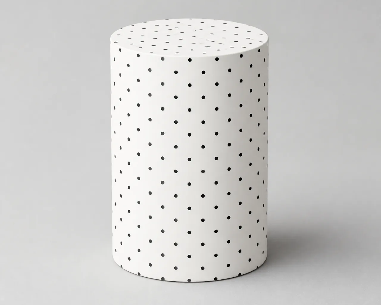 Minh họa cho “Hoa văn bề mặt”: a plain white cylinder covered only in small evenly spaced black dots.